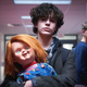 Teenager Jake Wheeler (Zackary Arthur) carries a grinning Chucky doll down the hall of his middle school.